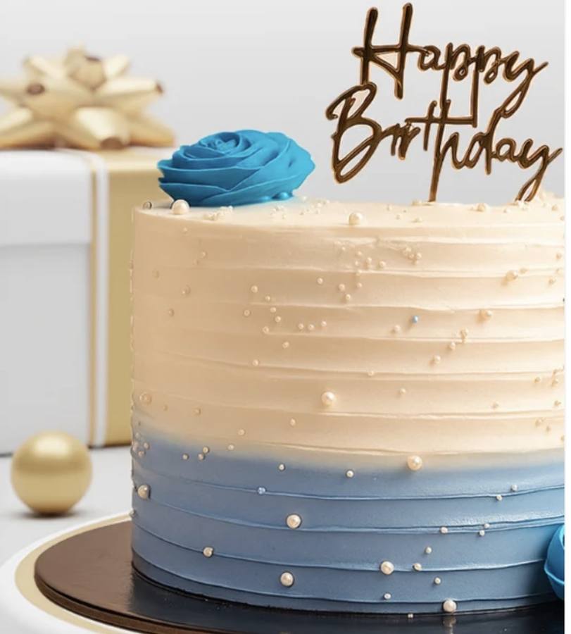 Blue and cream birthday cake with gold Happy Birthday topper