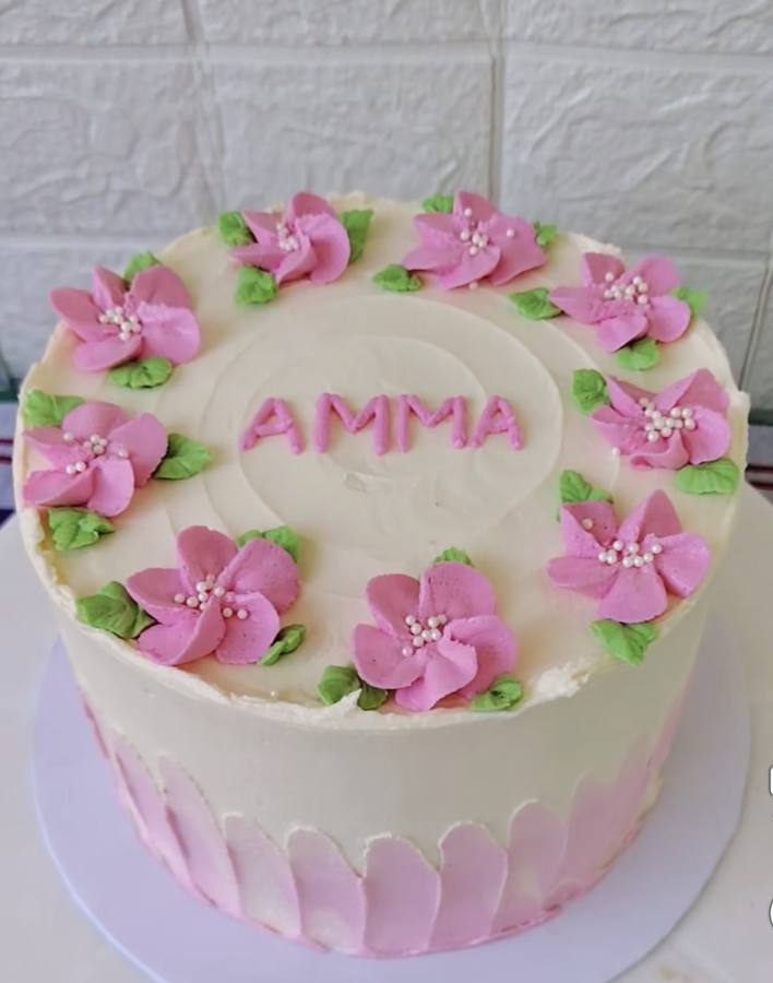 Personalised floral cake with pink flower decorations — custom cakes Auckland